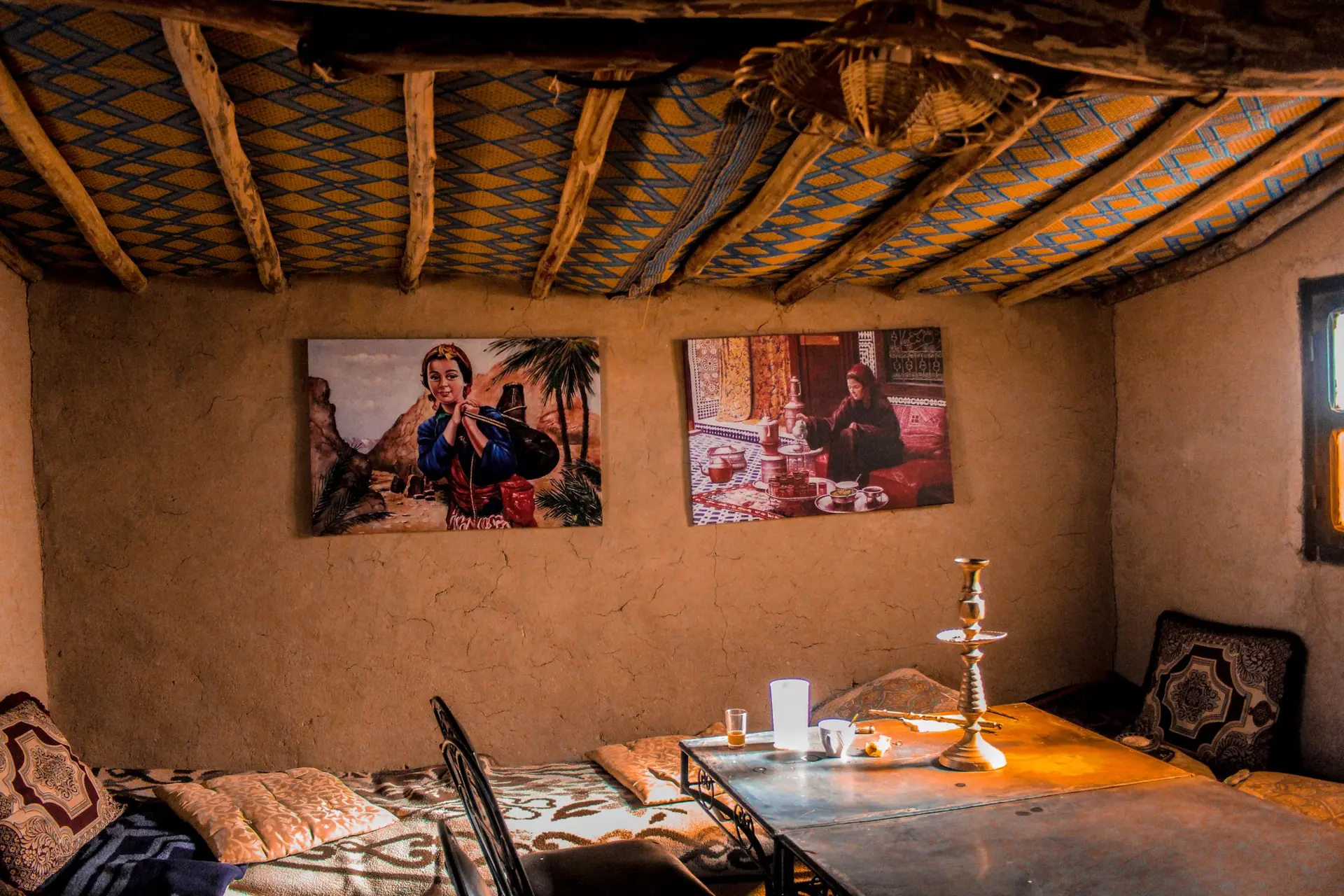 Cozy Moroccan room with traditional decor, art, and warm ambiance.